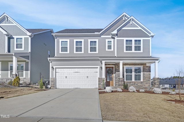 craftsman-style home with a front yard and a garage