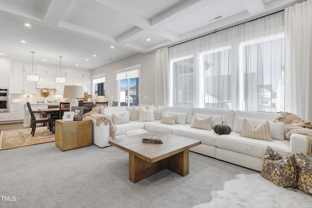 carpeted living room with beamed ceiling and coffered ceiling