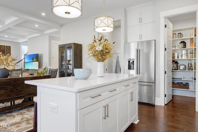 kitchen with white cabinetry, coffered ceiling, beamed ceiling, high end refrigerator, and a center island