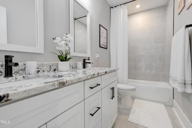 full bathroom featuring toilet, vanity, tile patterned floors, and shower / bath combo with shower curtain