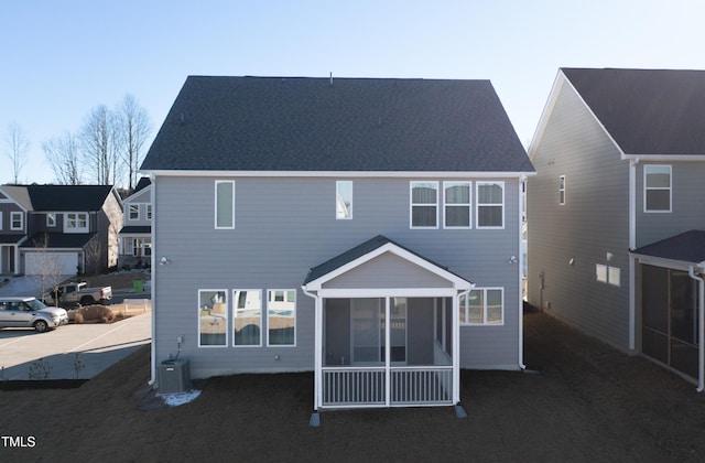 back of house with a sunroom and central AC unit