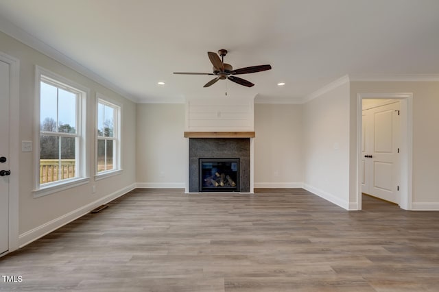 unfurnished living room with hardwood / wood-style flooring, crown molding, and ceiling fan