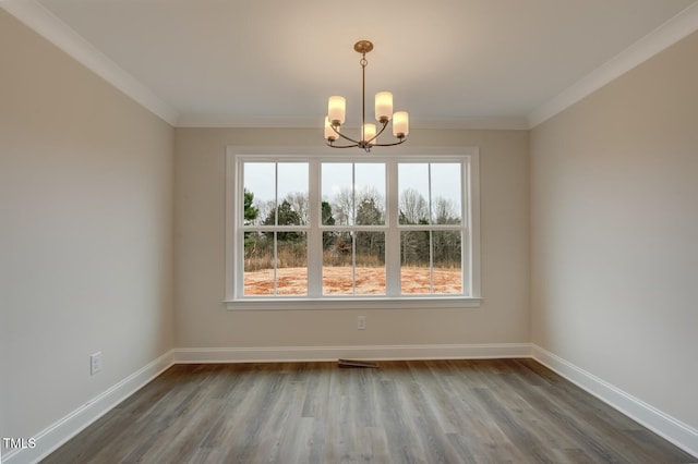 unfurnished dining area featuring an inviting chandelier, hardwood / wood-style floors, and ornamental molding