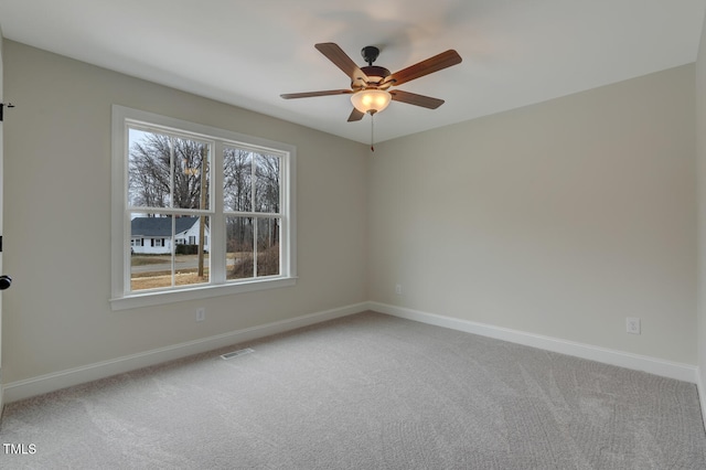 empty room featuring ceiling fan and carpet flooring