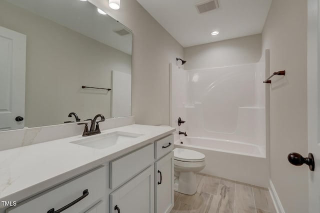 full bathroom featuring vanity, tub / shower combination, and toilet