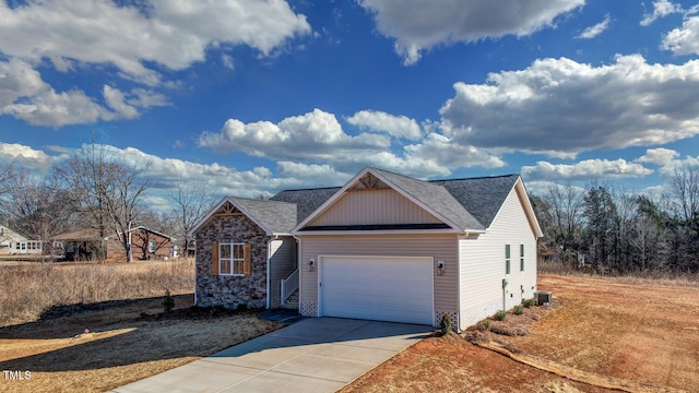 view of front of property featuring central AC unit and a garage