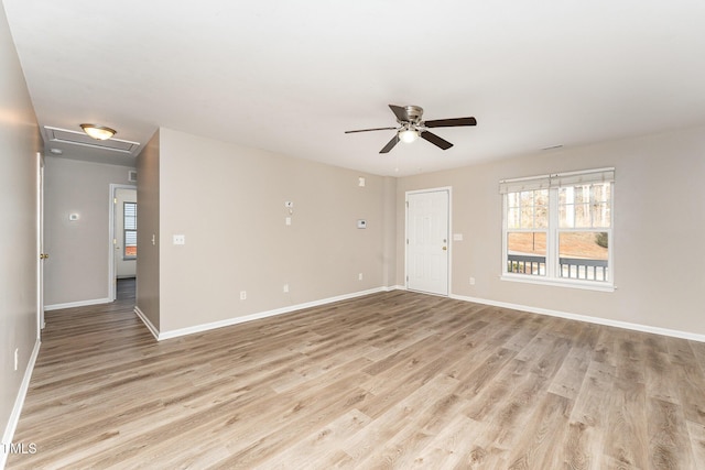 empty room with ceiling fan and light hardwood / wood-style floors