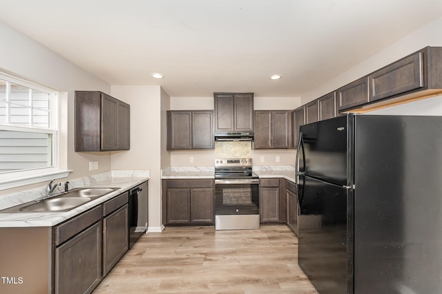 kitchen with sink, black appliances, dark brown cabinets, and light hardwood / wood-style flooring