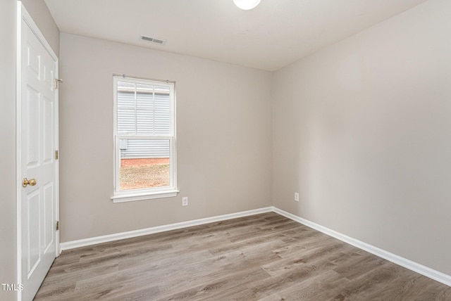 spare room with light hardwood / wood-style flooring