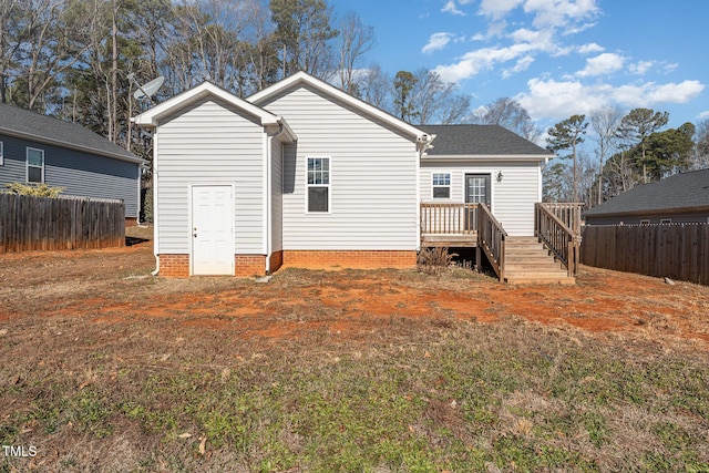 rear view of property with a yard and a deck