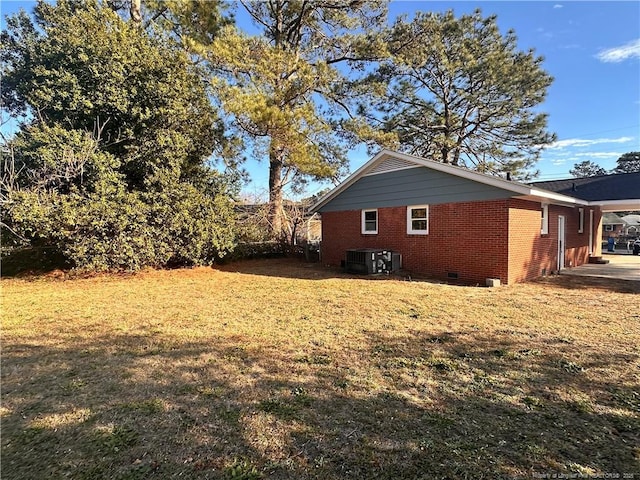 view of property exterior with a lawn and cooling unit