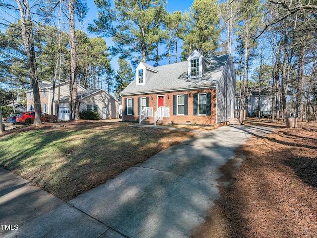 cape cod home with a front lawn