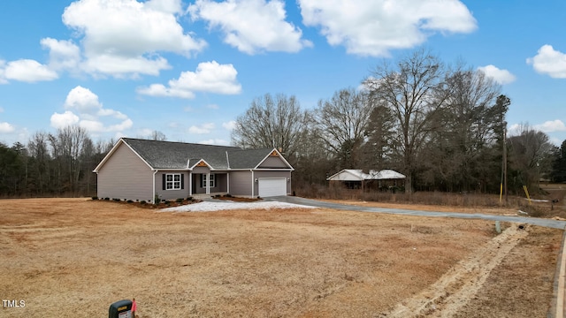 view of front of property with a front lawn and a garage