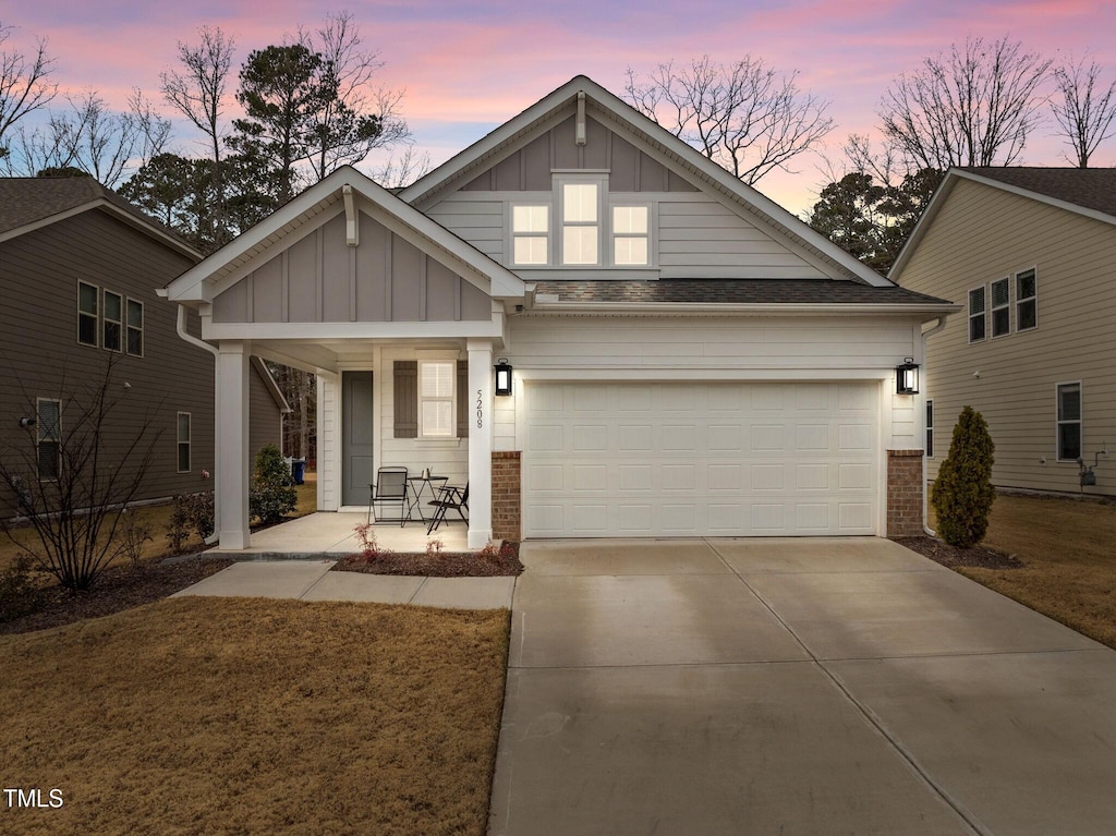 craftsman-style house featuring covered porch and a garage