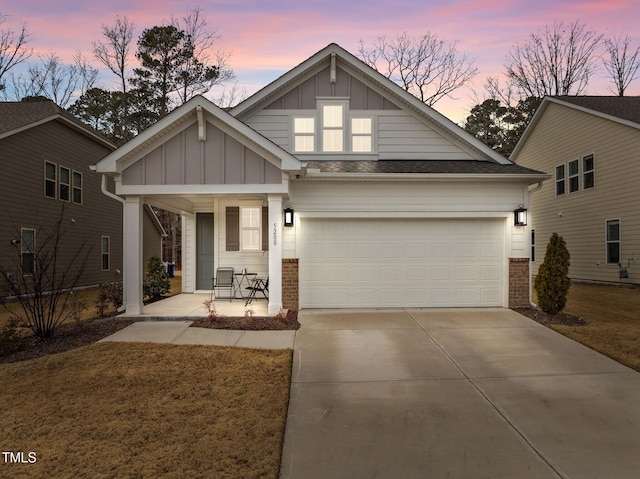 craftsman-style house featuring covered porch and a garage