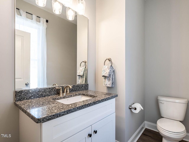 bathroom featuring hardwood / wood-style floors, toilet, and vanity