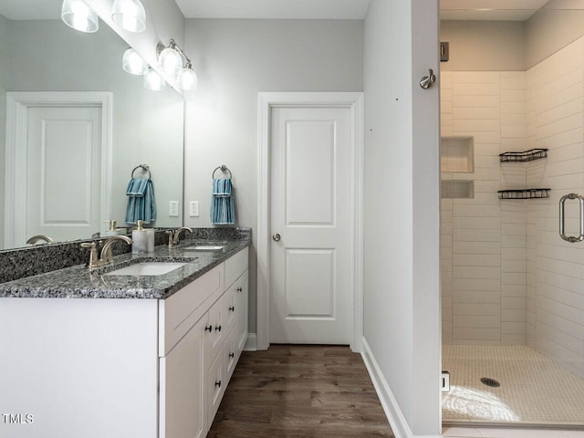 bathroom with vanity, walk in shower, and hardwood / wood-style floors