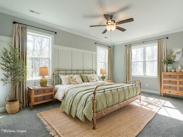 bedroom with ornamental molding, dark colored carpet, and ceiling fan