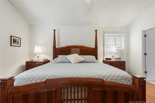 bedroom featuring hardwood / wood-style flooring and vaulted ceiling