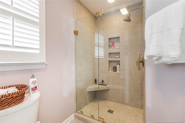 bathroom with walk in shower and toilet