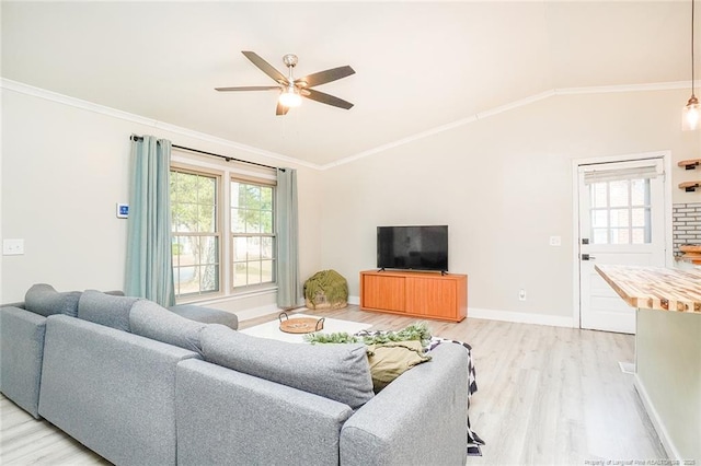 living room featuring ceiling fan, light wood-type flooring, ornamental molding, and vaulted ceiling