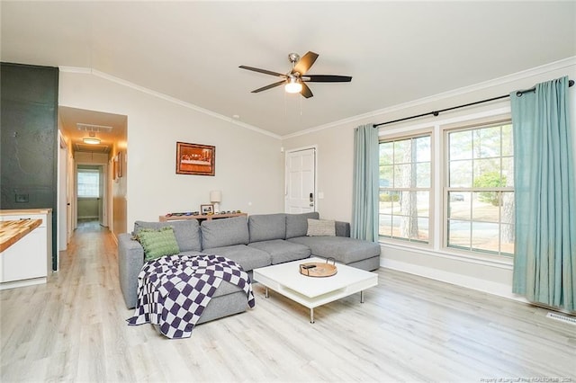 living room featuring crown molding, ceiling fan, vaulted ceiling, and light wood-type flooring