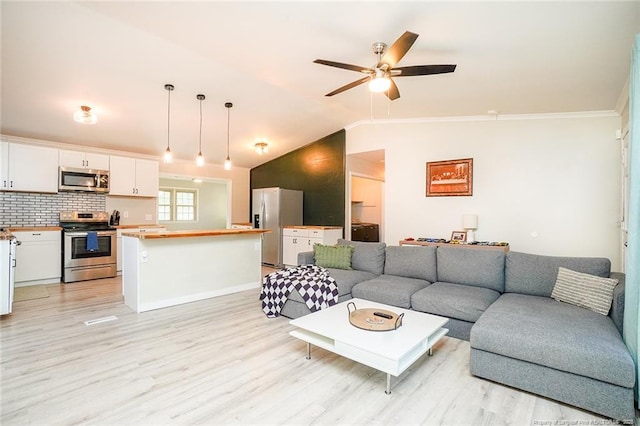 living room featuring ceiling fan, light hardwood / wood-style floors, lofted ceiling, and ornamental molding