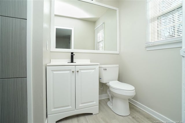 bathroom featuring hardwood / wood-style floors, vanity, and toilet