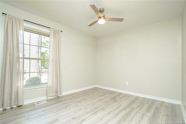 empty room with light hardwood / wood-style floors and ceiling fan