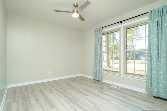 unfurnished room with ceiling fan and light hardwood / wood-style floors