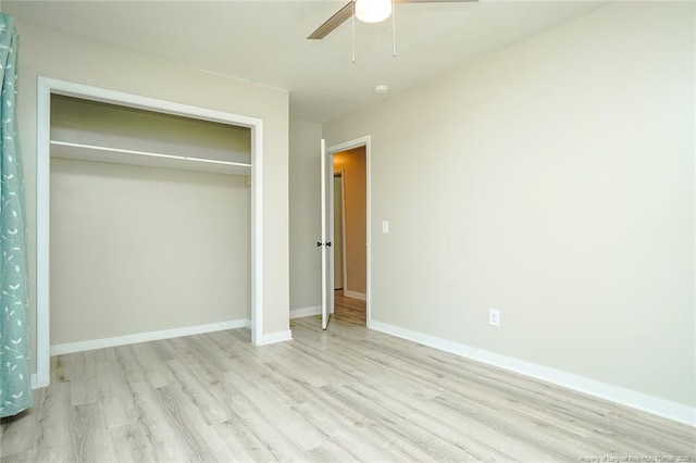 unfurnished bedroom with ceiling fan, light hardwood / wood-style flooring, and a closet