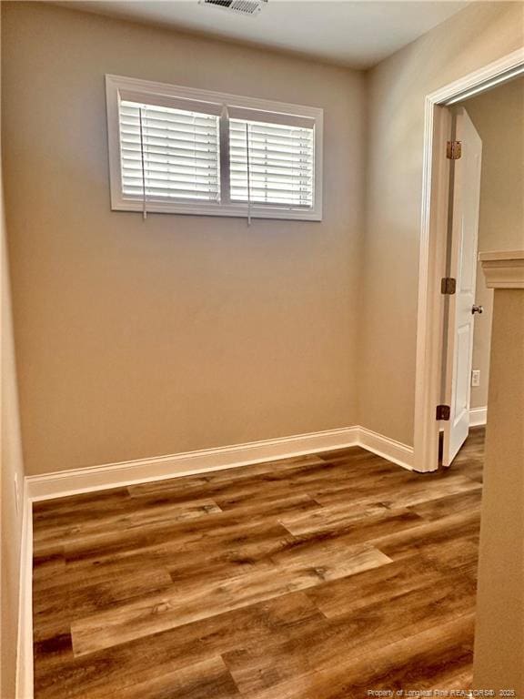 unfurnished room with wood-type flooring