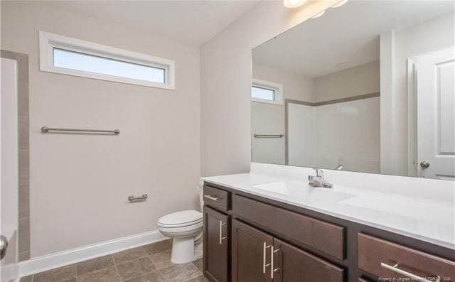 bathroom with a shower, vanity, and toilet