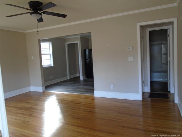 spare room featuring crown molding, dark hardwood / wood-style flooring, and ceiling fan