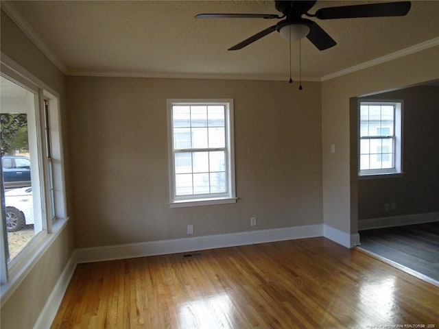 unfurnished room with ceiling fan, wood-type flooring, and ornamental molding