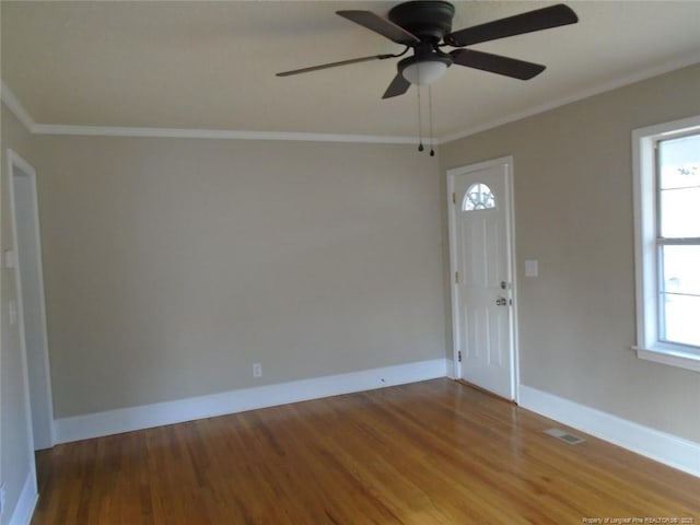 unfurnished room featuring ceiling fan, wood-type flooring, and ornamental molding