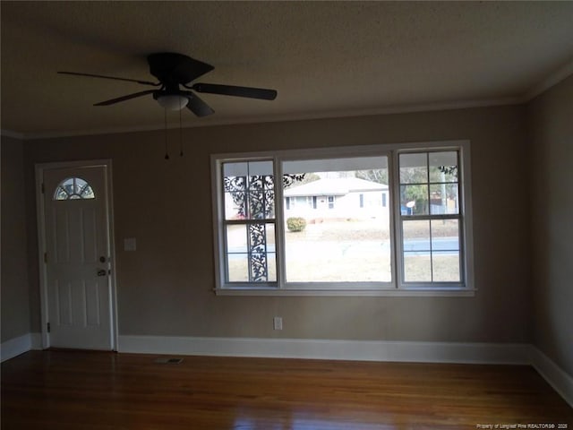 foyer entrance with ceiling fan, crown molding, a textured ceiling, and hardwood / wood-style flooring