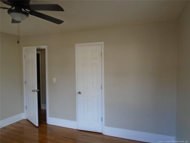 unfurnished bedroom featuring dark hardwood / wood-style flooring and ceiling fan