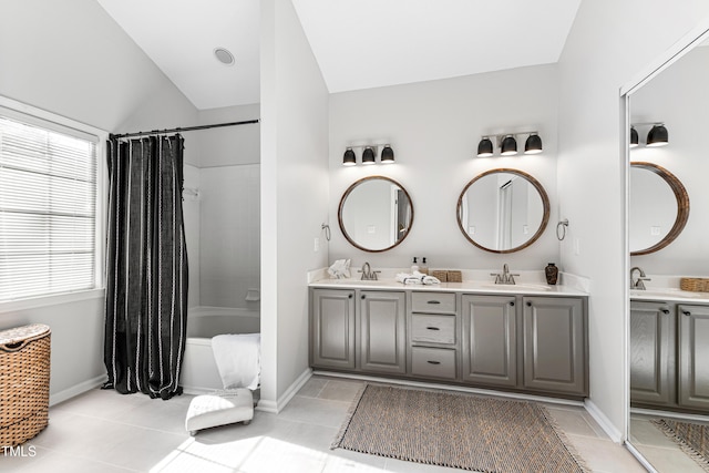 bathroom featuring vanity, tile patterned flooring, vaulted ceiling, and shower / bath combo with shower curtain