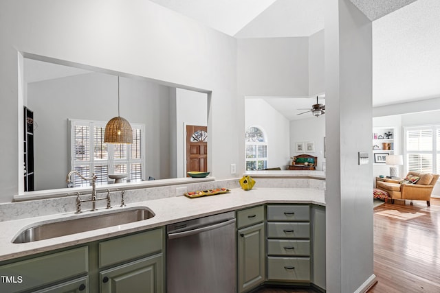 kitchen featuring dishwasher, ceiling fan, plenty of natural light, sink, and lofted ceiling