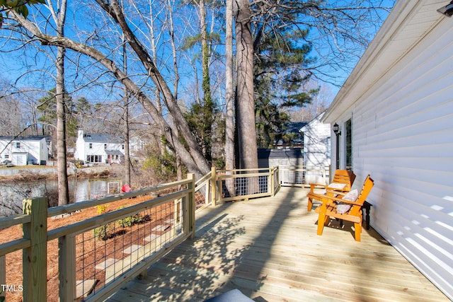 wooden terrace featuring a water view