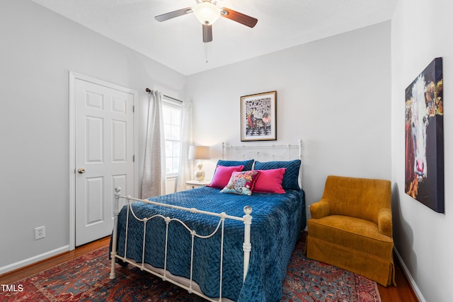 bedroom with ceiling fan and wood-type flooring