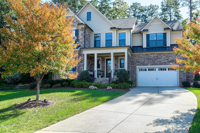 craftsman house featuring a garage, a porch, and a front lawn