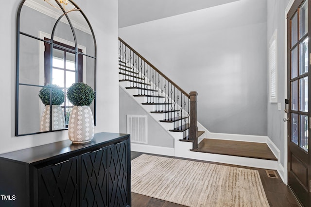 entryway featuring dark hardwood / wood-style flooring and ornamental molding