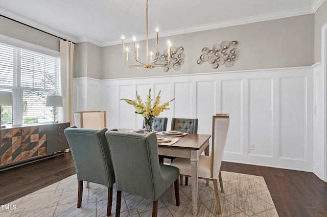 dining space featuring ornamental molding, dark hardwood / wood-style flooring, and a chandelier