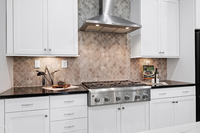 kitchen with backsplash, white cabinets, wall chimney exhaust hood, and stainless steel gas cooktop