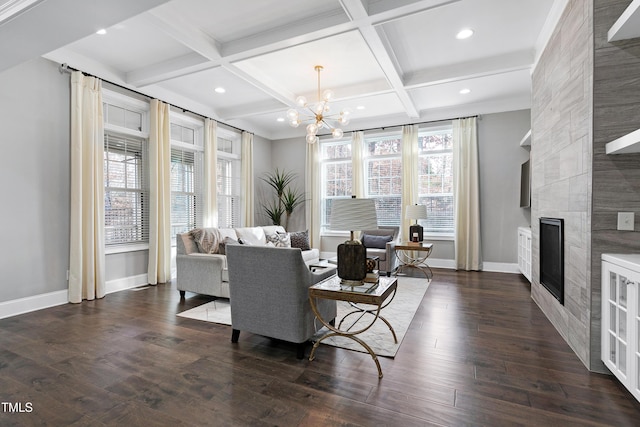 living room with coffered ceiling, a tile fireplace, a wealth of natural light, and dark hardwood / wood-style floors