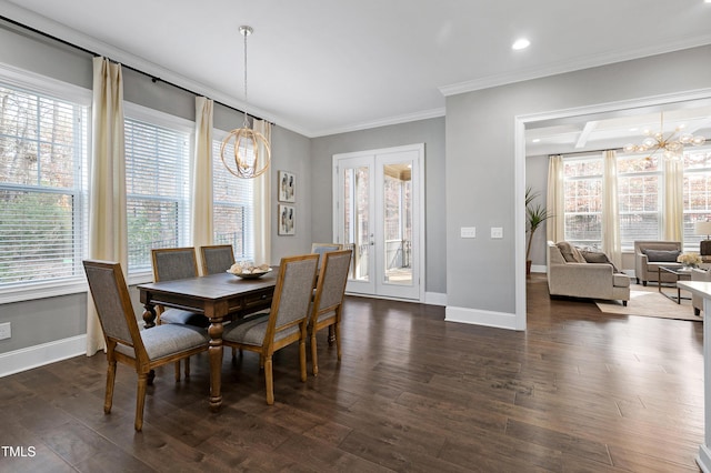 dining room featuring dark wood-type flooring, ornamental molding, french doors, and an inviting chandelier