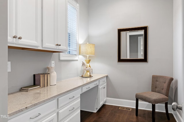 interior space with built in desk and dark hardwood / wood-style floors