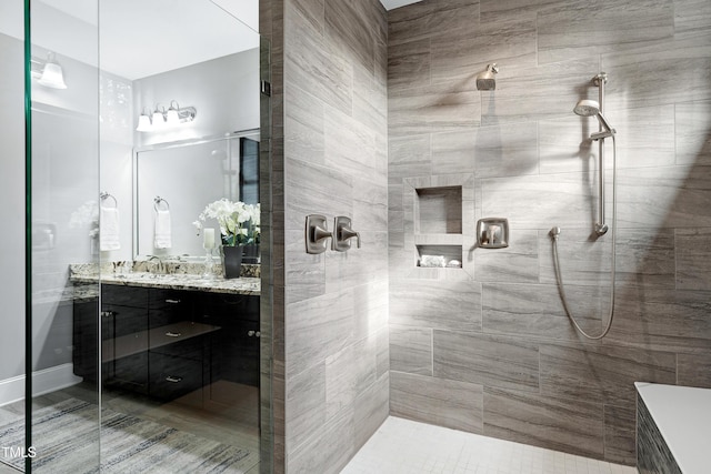 bathroom with vanity and a shower with shower door